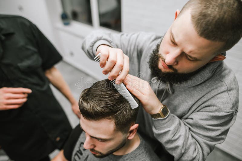 Barber Finishes the Haircut of the Client,combs the Hair with a Comb and Wax. Male Hairdresser Doing Client`s Hair Styling Stock Photo - Image of barbershop, fashion: 185514812 Barber Finishes the Haircut of the Client,combs the Hair with a Comb and Wax. Male Hairdresser Doing Client`s Hair Styling Stock Photo - Image of barbershop, fashion: 185514812