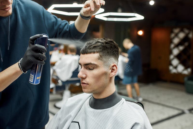 Barber Fixing Haircut of His Client with Hair Spray while Working in the  Barbershop. Young Man Visiting Barbershop Stock Image - Image of cutting,  care: 184002163