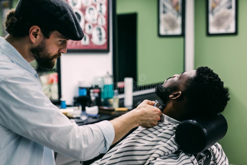 A Barber is Going through the Electric Cutting and Shaving Machine for the  Beard of an African-American Brazilian Boy Stock Image - Image of beauty,  business: 214303807