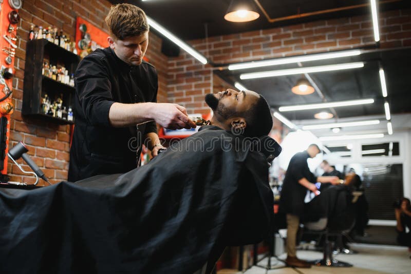 A Barber is Going through the Electric Cutting and Shaving Machine for the  Beard of an African-American Brazilian Boy Stock Image - Image of beauty,  business: 214303807