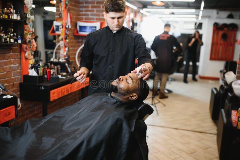 A Barber is Going through the Electric Cutting and Shaving Machine for the  Beard of an African-American Brazilian Boy Stock Image - Image of beauty,  business: 214303807