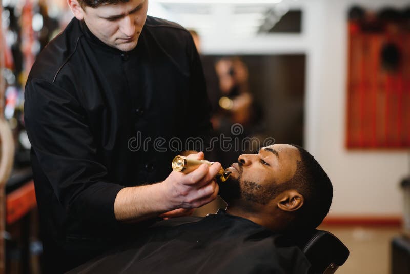 A Barber is Going through the Electric Cutting and Shaving Machine for the  Beard of an African-American Brazilian Boy Stock Image - Image of beauty,  business: 214303807