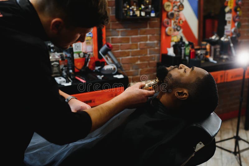 A Barber is Going through the Electric Cutting and Shaving Machine for the  Beard of an African-American Brazilian Boy Stock Image - Image of beauty,  business: 214303807