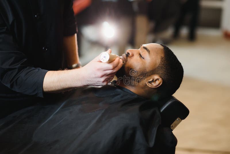 A Barber is Going through the Electric Cutting and Shaving Machine for the  Beard of an African-American Brazilian Boy Stock Image - Image of beauty,  business: 214303807