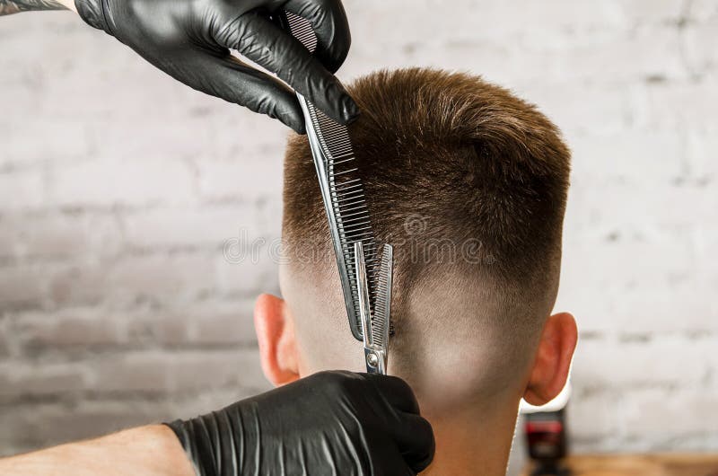 Barber Hand in Gloves Cut Hair and Shaves Young Man on a Brick Wall  Background. Close Up Side Portrait of a Guy, Back View Stock Image - Image  of hairstyle, beauty: 148423807