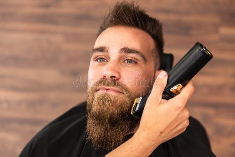 A Barber is Going through the Electric Cutting and Shaving Machine for the  Beard of an African-American Brazilian Boy Stock Image - Image of beauty,  business: 214303807