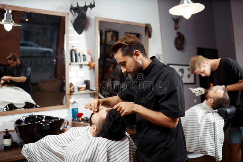 Barber working with client in chair royalty free stock photo