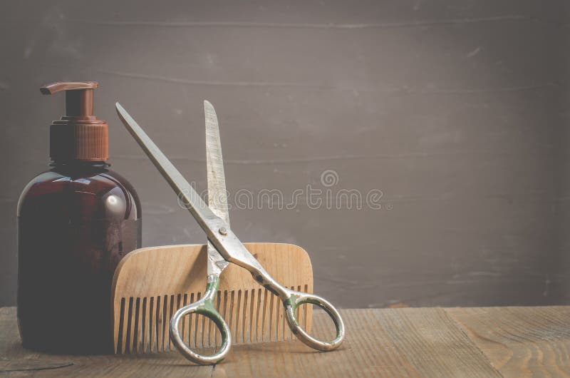 Barbershop concept. Old style. Hairbrushes, sprayer and a scissors on a gray background with copy space. Selective focus