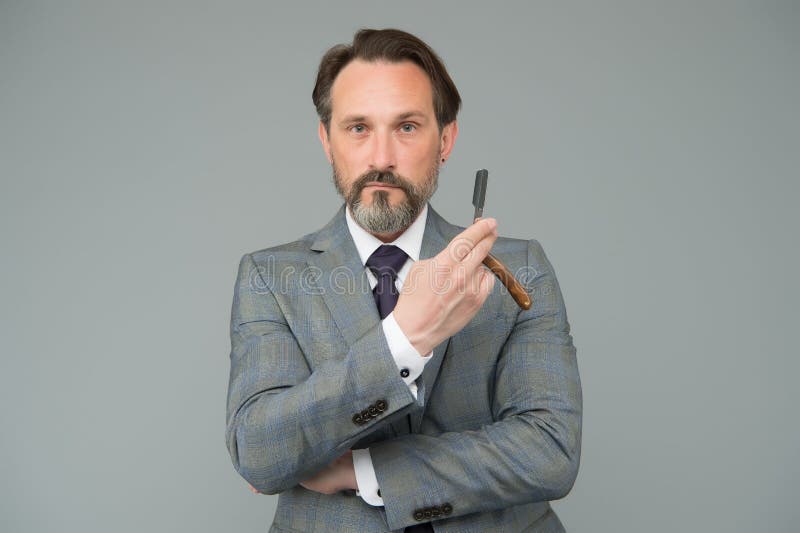 Barbershop interested in your hair. Boss hold razor blade. Barber tool. Bearded man in formal style. Retro barbershop royalty free stock photography Barbershop interested in your hair. Boss hold razor blade. Barber tool. Bearded man in formal style. Retro barbershop royalty free stock photography