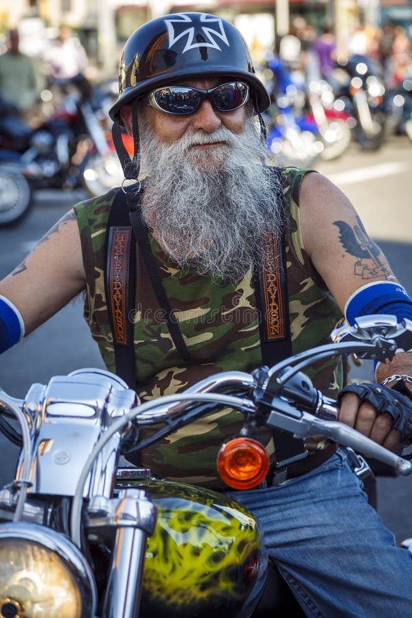 BARCELONA, SPAIN - JULY 06: Unidentified persons with typical biker jacket a Harley Davidson motorbike at an exhibition during BARCELONA HARLEY DAYS 2013, on July 06, 2013, Barcelona, Spain.