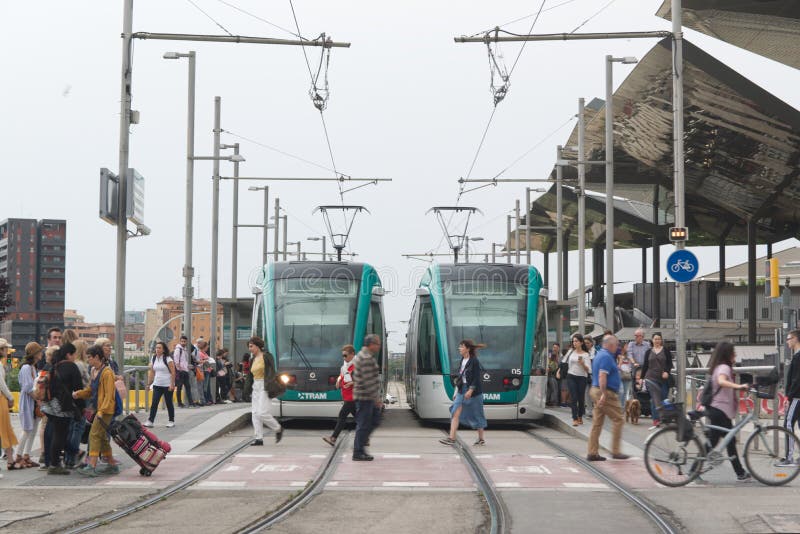 BARCELONA JUNE 14, 2019: Two tram trains on the rails and a crowd next to the tramway station in Barcelona stock photography BARCELONA JUNE 14, 2019: Two tram trains on the rails and a crowd next to the tramway station in Barcelona stock photography