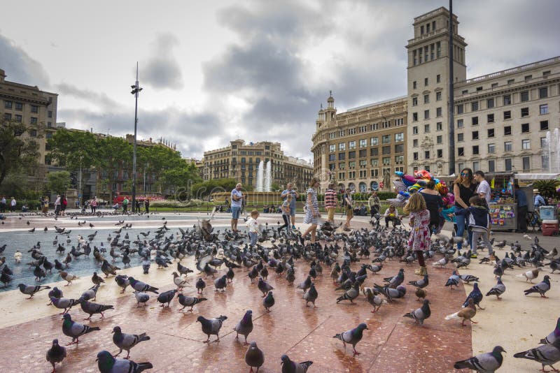 Barcelona, May 07, 2017: People feeding the pigeons in Placa de Catalunya near La Rambla stock photography Barcelona, May 07, 2017: People feeding the pigeons in Placa de Catalunya near La Rambla stock photography