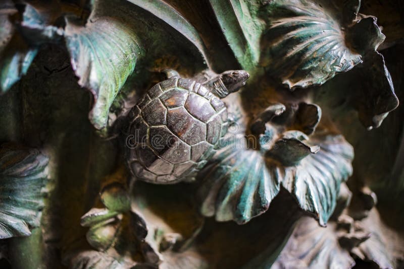 Elements of insects, flowers, birds of mammals on the old entrance gate to the Temple of the Holy Family.