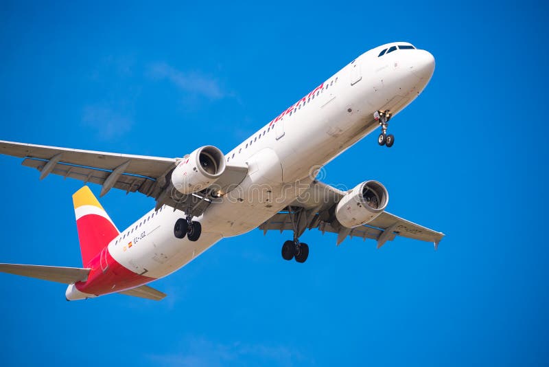 BARCELONA, SPAIN - AUGUST 20, 2016: Iberia Airlines plane arriving at Airport on schedule. Isolated on blue background. Close-up. BARCELONA, SPAIN - AUGUST 20, 2016: Iberia Airlines plane arriving at Airport on schedule. Isolated on blue background. Close-up