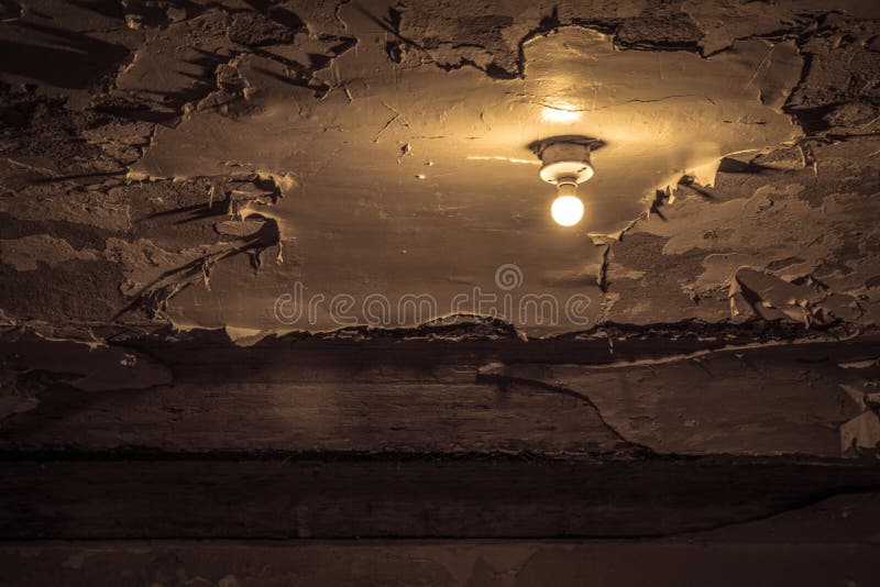 Bare Light Bulb On Water Damaged Ceiling