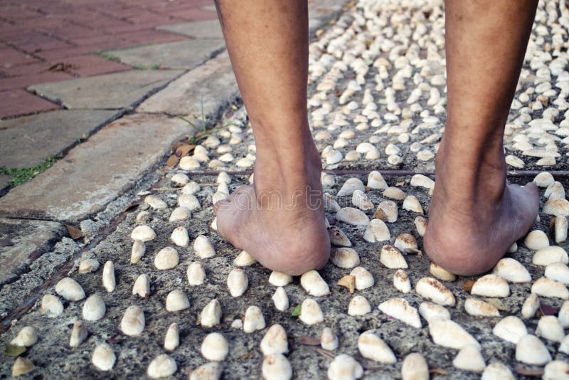 Barefoot at Cement Stone Track for Massage the Soles of the Feet from