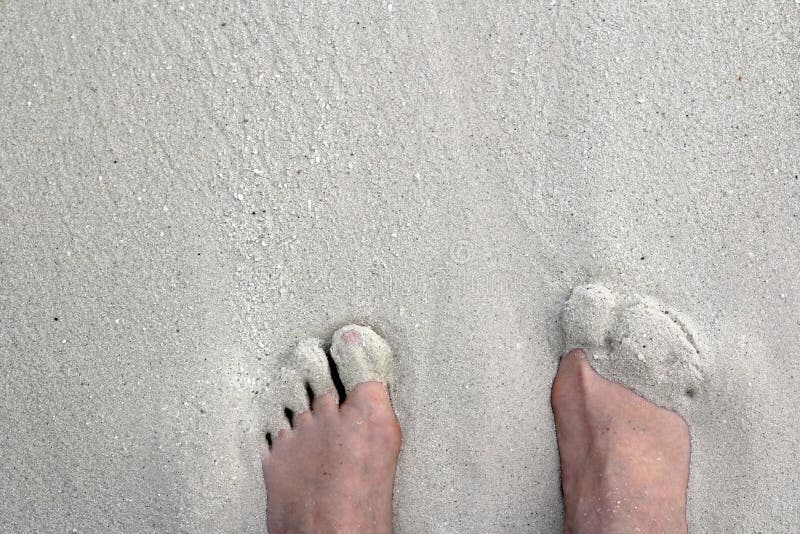 Barefoot in holiday on the sandy beach. Barefoot in holiday on the sandy beach