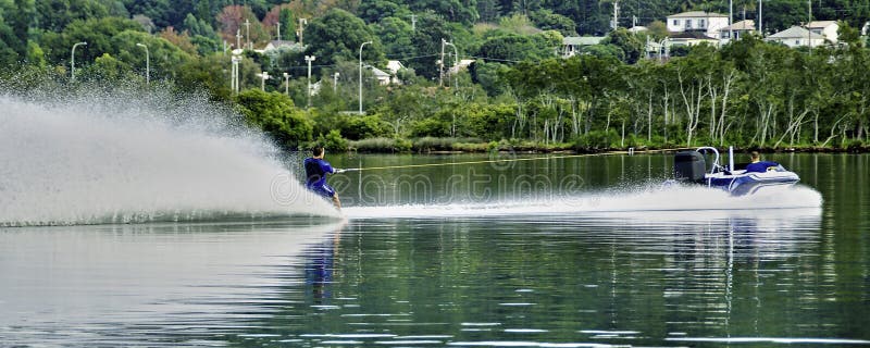 Barefoot water skiier at speed on tranquil water royalty free stock photography Barefoot water skiier at speed on tranquil water royalty free stock photography