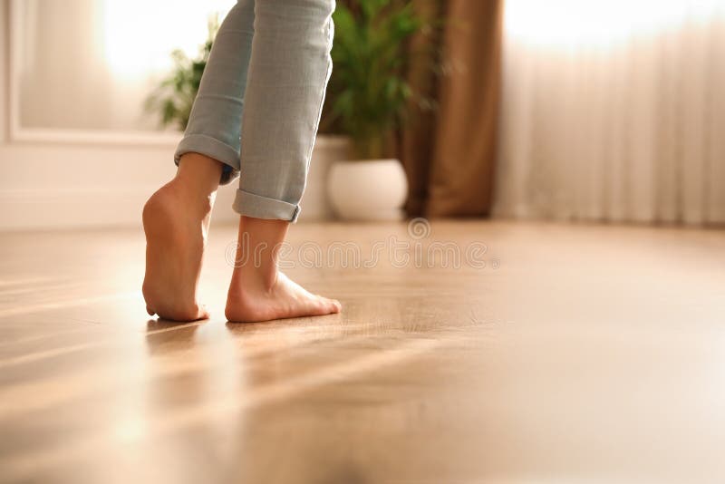 Barefoot woman at home, closeup. Floor heating system royalty free stock photography