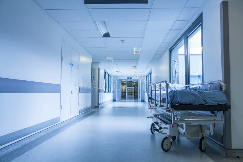 Bereavement, death or loss concept shot of empty bed, gurney or stretcher with drip in hospital corridor. Bereavement, death or loss concept shot of empty bed, gurney or stretcher with drip in hospital corridor