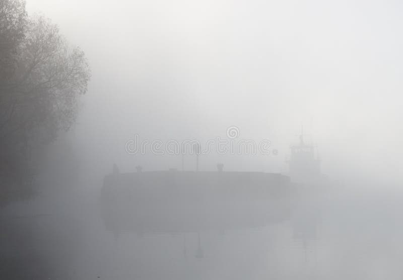 Barge ship in thick fog