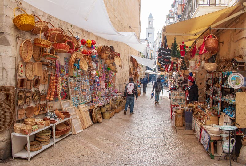 View of a narrow street in Bari, Puglia, Italy, Bari vecchia, traditional open market shops with souvenir for tourists. View of a narrow street in Bari, Puglia, Italy, Bari vecchia, traditional open market shops with souvenir for tourists