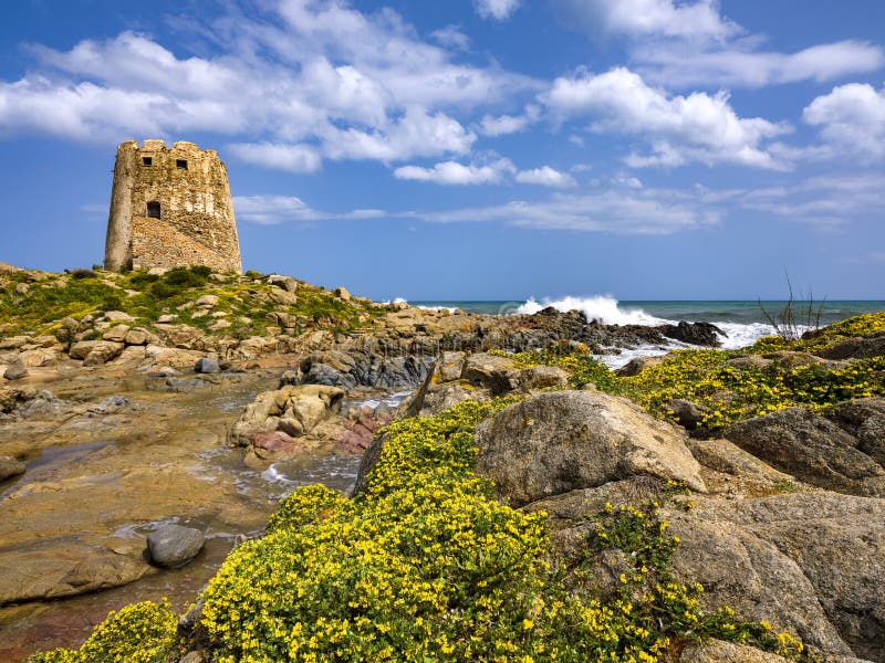 The symbol of the city of Bari Sardo, a tower built on a rocky outcrop on the sea with crystalline water, in the spring season. The symbol of the city of Bari Sardo, a tower built on a rocky outcrop on the sea with crystalline water, in the spring season