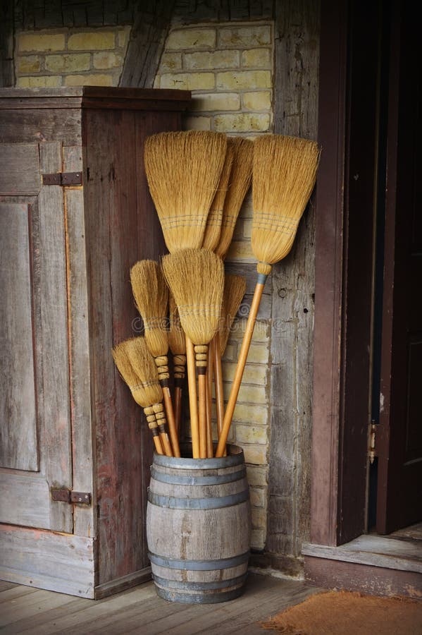 An old antique barrel of straw brooms of various sizes for sweeping floors at Old World Wisconsin in Eagle, WI. An old antique barrel of straw brooms of various sizes for sweeping floors at Old World Wisconsin in Eagle, WI.