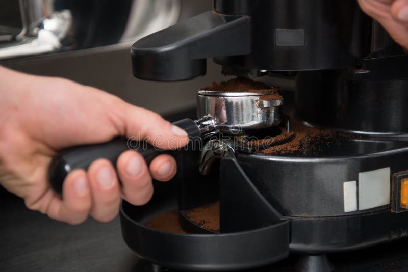 Barista Using Special Brush while Cleaning Parts of Coffee Machine