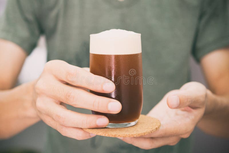 Barista dienende koffie terwijl status in koffiewinkel Nadruk die op mannelijke handen de koude kop van het koffieglas houden stock foto's Barista dienende koffie terwijl status in koffiewinkel Nadruk die op mannelijke handen de koude kop van het koffieglas houden stock foto's