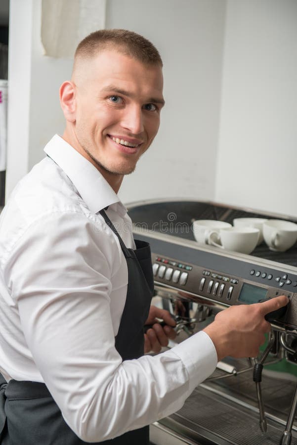 Barista Using Special Brush while Cleaning Parts of Coffee Machine