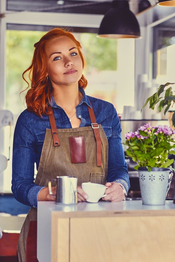 Barista femminile in una piccola caffetteria fotografie stock