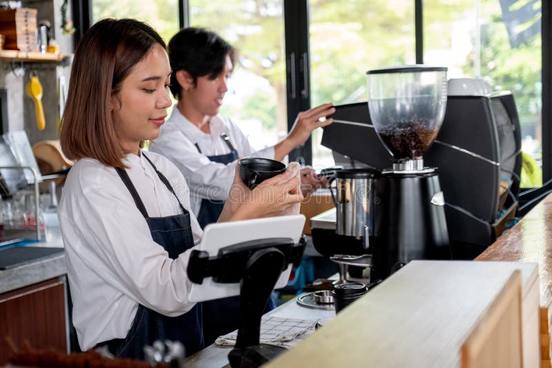 https://thumbs.dreamstime.com/b/barista-girl-coffee-maker-woman-use-towel-clean-cup-her-co-worker-work-machine-concept-happy-working-small-216324660.jpg