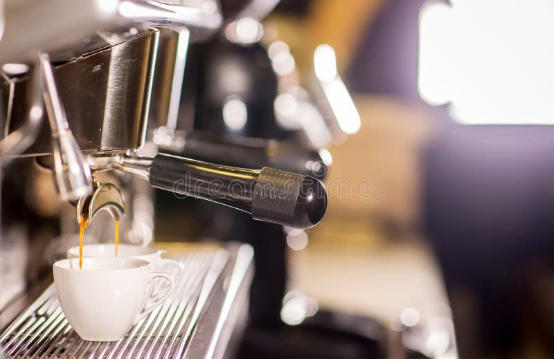 Barista make coffee espresso shot by streaming machine in coffee cafeteria bar. royalty free stock image Barista make coffee espresso shot by streaming machine in coffee cafeteria bar. royalty free stock image