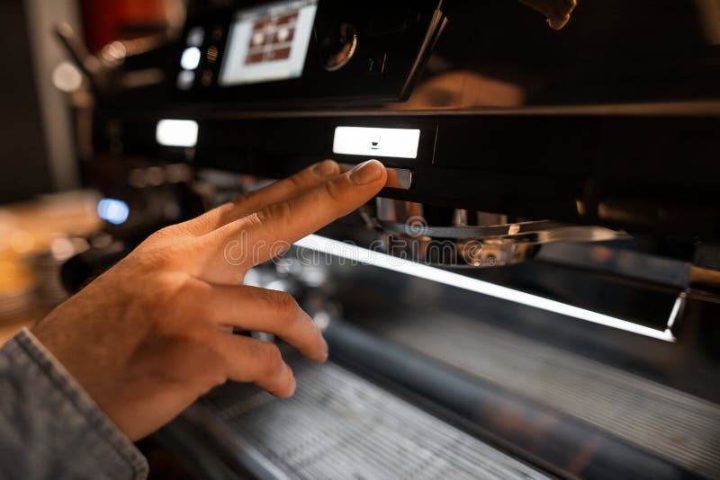 Barista Man Hand Presses the Start Button. Bartender Making Coffee in a