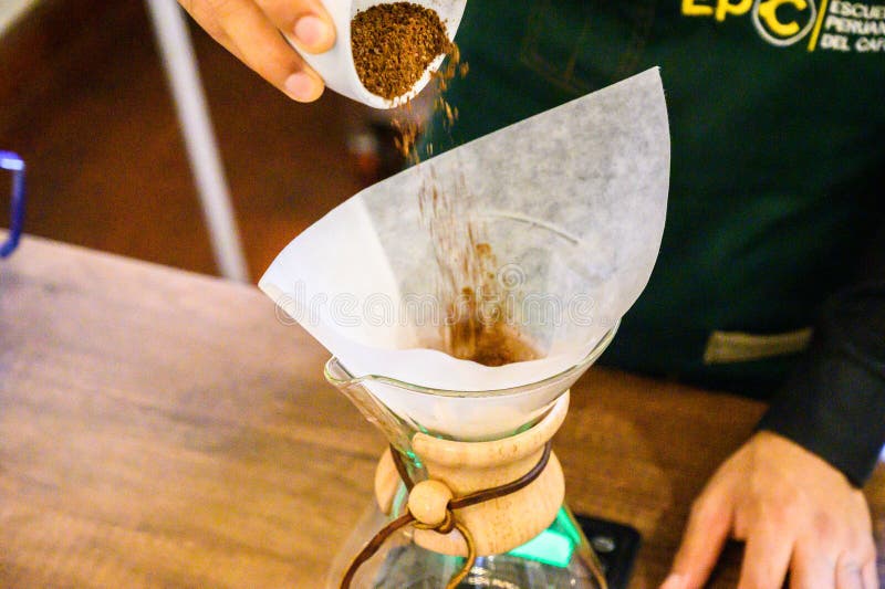Barista preparing pour over coffee using chemex method royalty free stock image