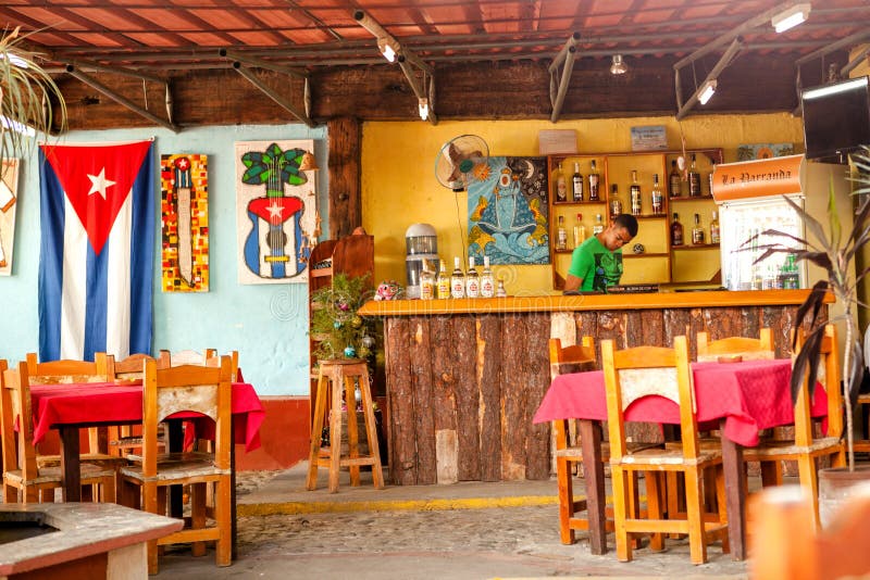 Barkeeper in a bar/ restaurant in Trinidad, Cuba. Trinidad, Cuba - December 18, 2016: Barkeeper in a bar/ restaurant in Trinidad, Cuba royalty free stock photography Barkeeper in a bar/ restaurant in Trinidad, Cuba. Trinidad, Cuba - December 18, 2016: Barkeeper in a bar/ restaurant in Trinidad, Cuba royalty free stock photography