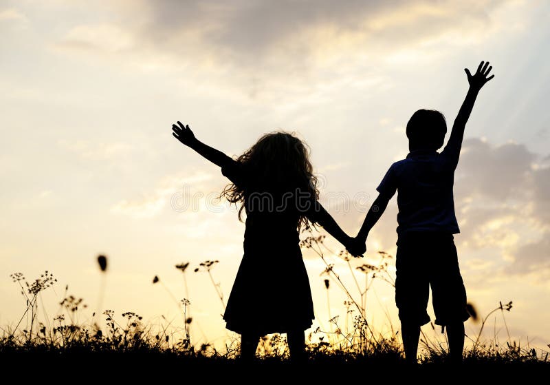 Silhouette, group of happy children playing on meadow, sunset, s. Silhouette, group of happy children playing on meadow, sunset, s