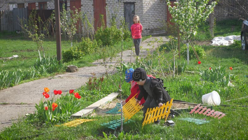 Barn leker på bakgården på en solig dag. arkivfilmer