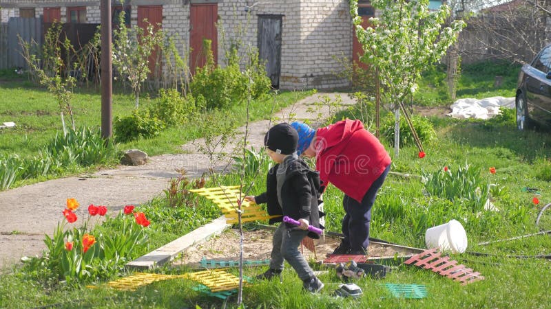 Barn leker på bakgården på en solig dag. lager videofilmer