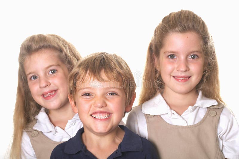 Three school children isolated on white. Three school children isolated on white