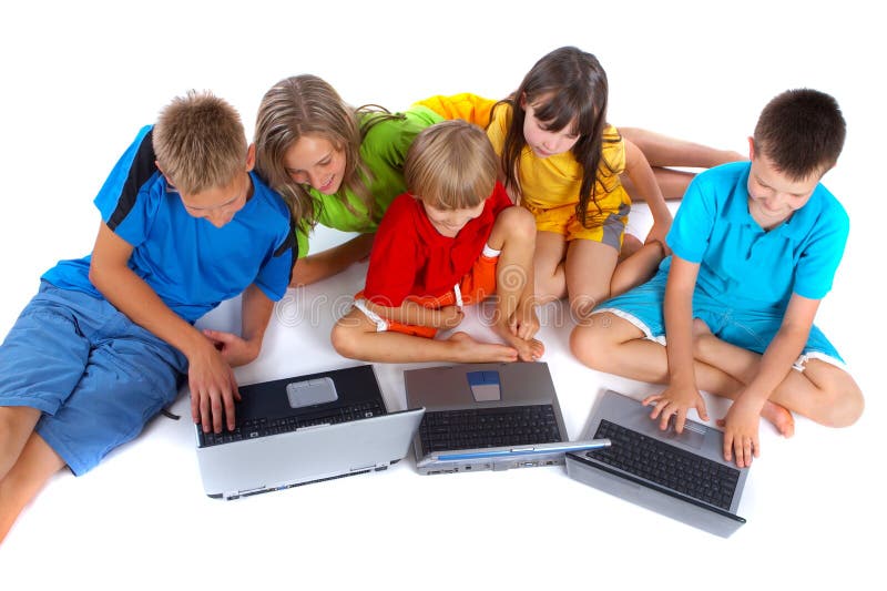 Five children sitting in a semi-circle on the floor, looking at three laptop computers in front of them. Isolated on white background. Taken from high perspective downward toward models. Five children sitting in a semi-circle on the floor, looking at three laptop computers in front of them. Isolated on white background. Taken from high perspective downward toward models.