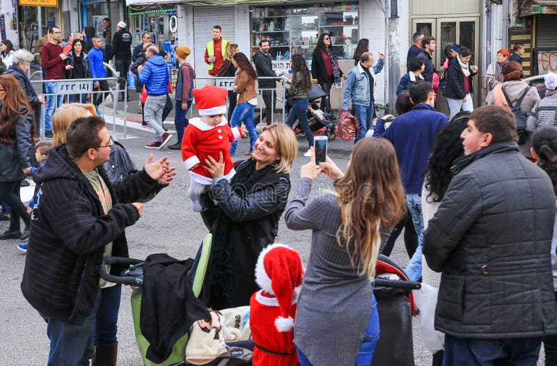 Barnet fostrar att gå med lilla Santa Claus på julmarknad arkivbild Barnet fostrar att gå med lilla Santa Claus på julmarknad arkivbild