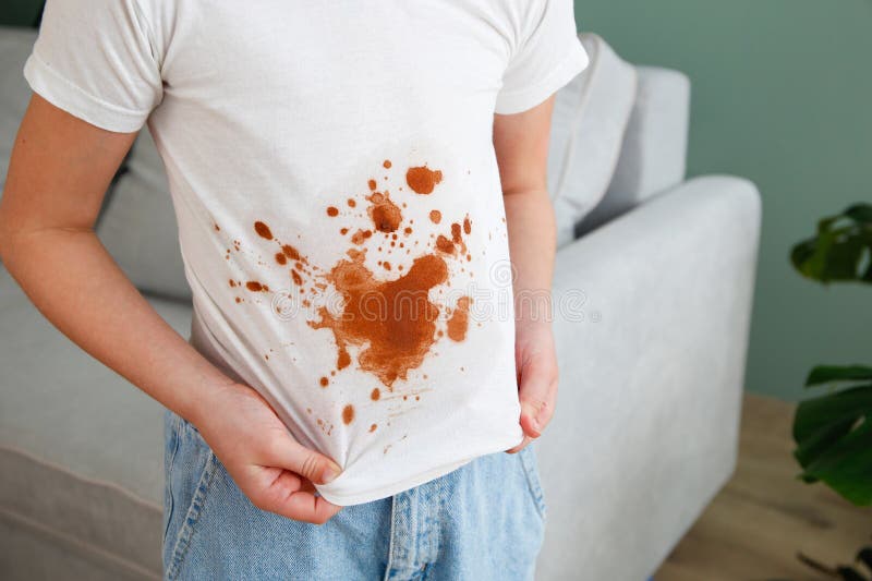 The child spilled coffee on his clothes. The concept of a stain on a t-shirt. The child spilled coffee on his clothes. The concept of a stain on a t-shirt.