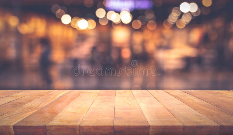 Barra contr?ria do tampo da mesa de madeira da textura com bokeh claro do ouro do borr?o no caf?, fundo do restaurante fotografia de stock royalty free Barra contr?ria do tampo da mesa de madeira da textura com bokeh claro do ouro do borr?o no caf?, fundo do restaurante fotografia de stock royalty free