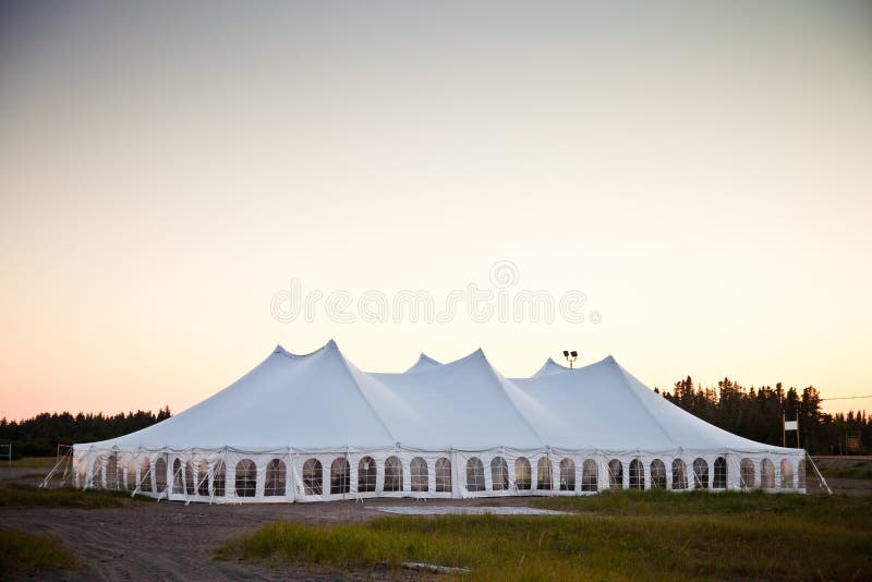 Party or event white tent during the evening. Party or event white tent during the evening