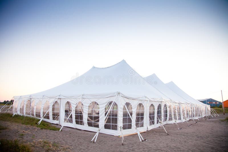 Party or event white tent during the evening. Party or event white tent during the evening