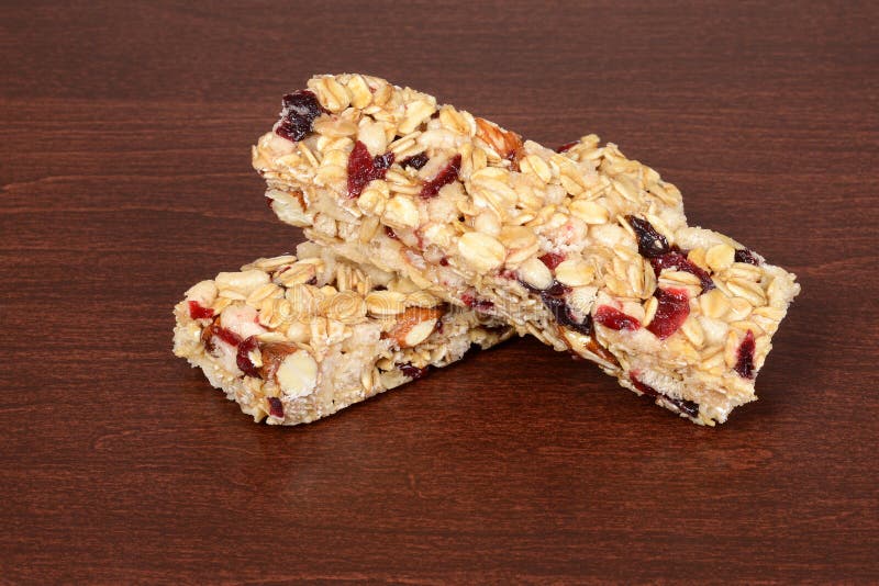 Fruit and nut granola bars on wood. Fruit and nut granola bars on wood