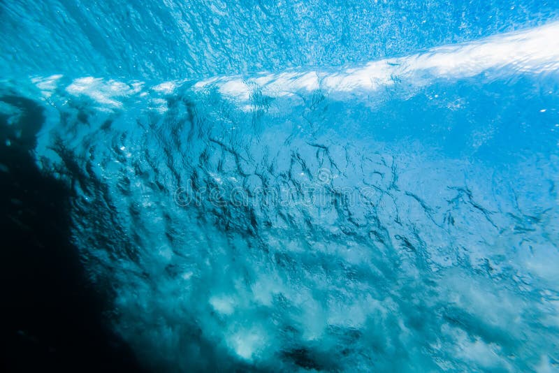 Barrel wave is underwater in ocean. Water texture