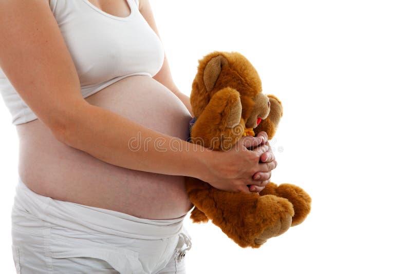 Barriga grávida com urso da peluche imagem de stock Barriga grávida com urso da peluche imagem de stock
